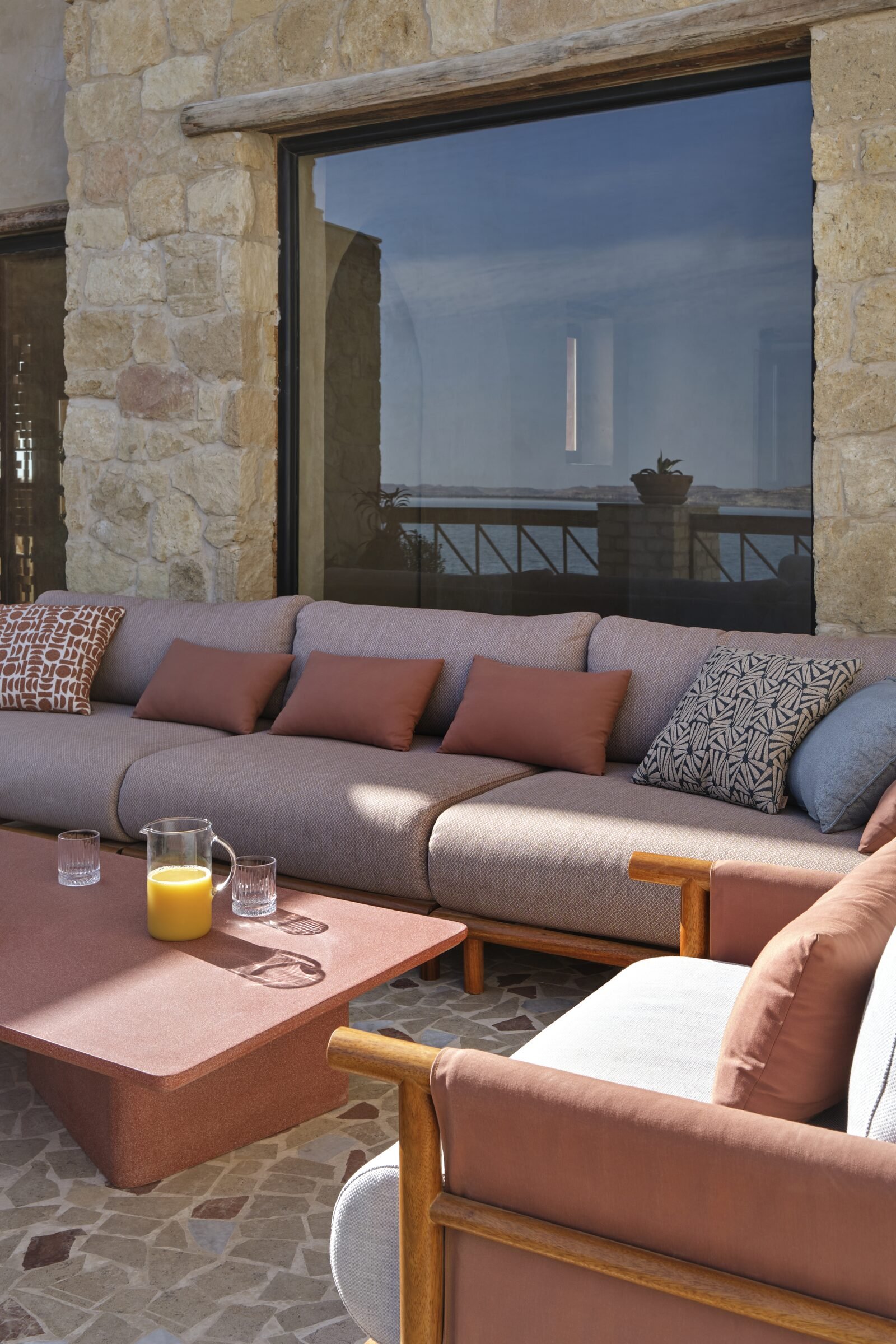 Rooftop sofa at Bayt Gagy, laid with fresh juice and fruit